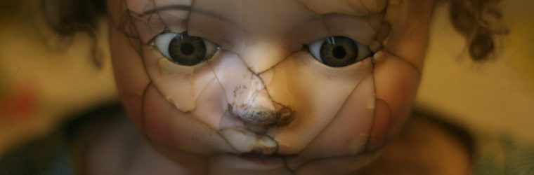 broken child's doll put together